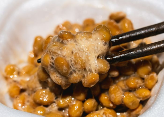 Natto that has been stirred with chopsticks, giving it a sticky, frothy texture.