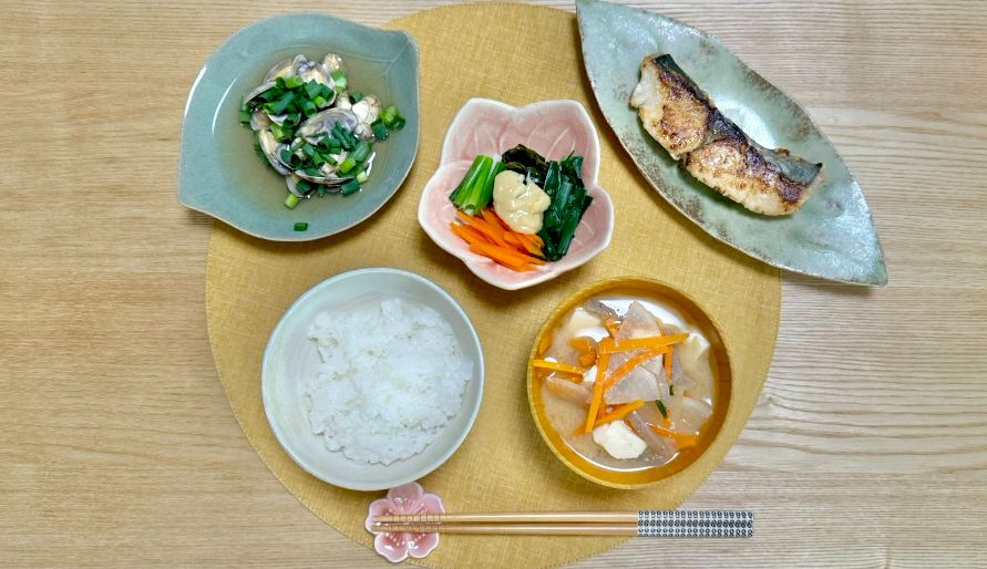 Bento meal with 5 dishes laid out on a table