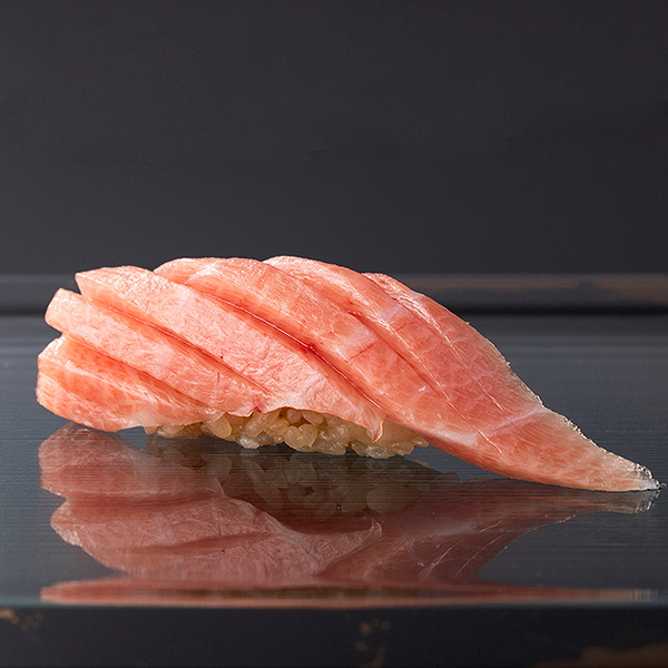 Premium sushi nigiri with fresh tuna on a sleek dark background