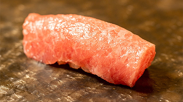 Premium sushi piece on elegant dark ceramic plate