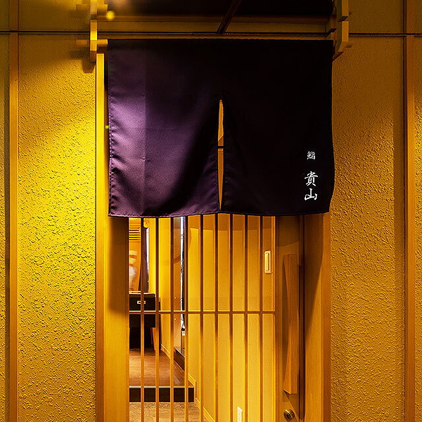 Elegant entrance of Japanese restaurant with traditional curtain