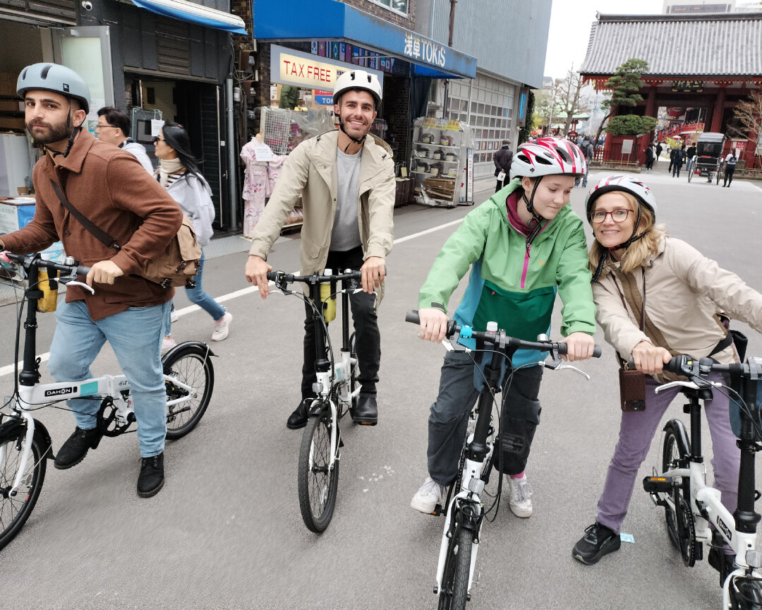 Two couples cycling through Asakusa on a bike tour.
