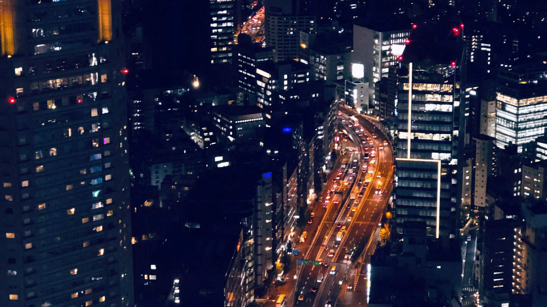 Vibrant Tokyo cityscape with illuminated buildings and streets at night