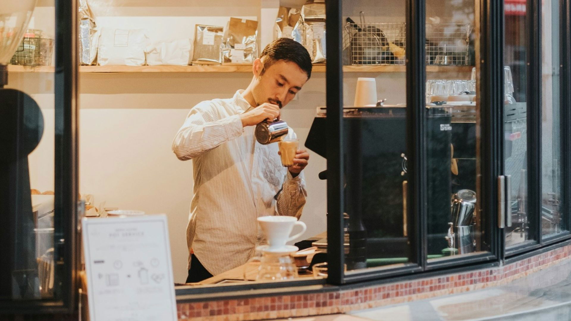 Barista crafting coffee in cozy cafe setting