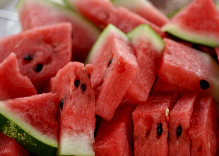 A close-up shot of lots of slices of fresh watermelon.