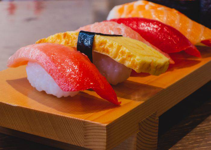 A plate of realistic fake food sample modeled after nigiri sushi