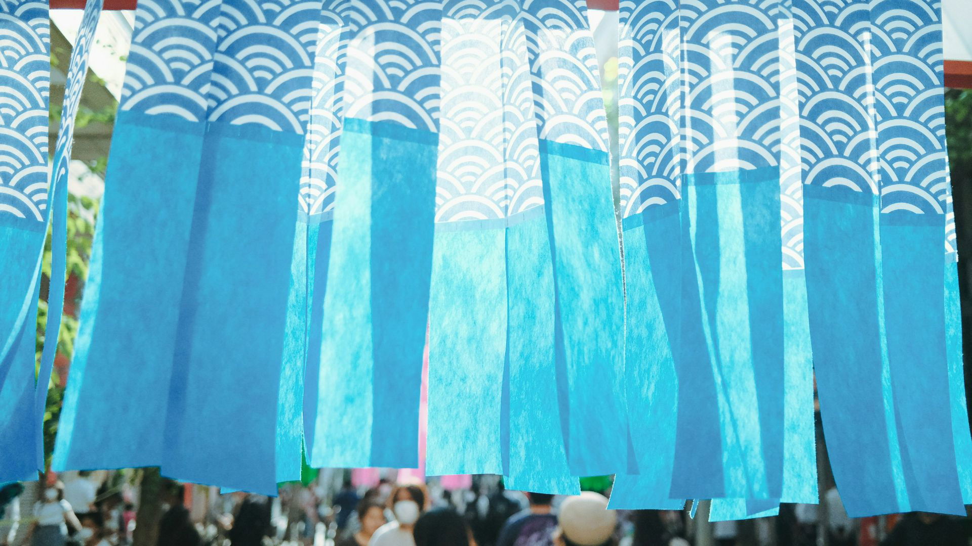 Blue and white decorative banners fluttering in outdoor market