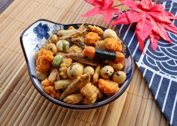 A bowl filled with a variety of ostumami snacks