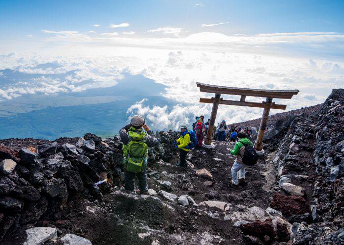 Hikers take a photo of the shrine entrance on Mt. Fuji