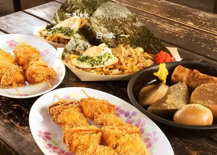 A selection of traditional Japanese dishes, including fried skewers and more.