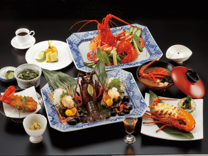 A luxurious course meal is laid out on a table featuring a variety of lobster dishes at Chunagon Tokyo Omori Bellport in Japan