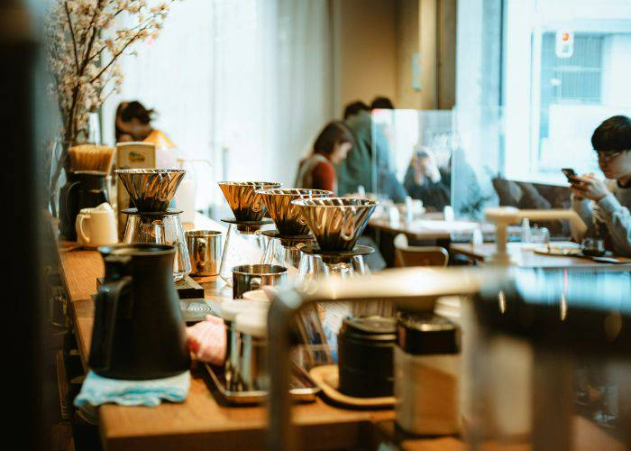 The interior of a quiet cafe with coffee brewing on the coffee.