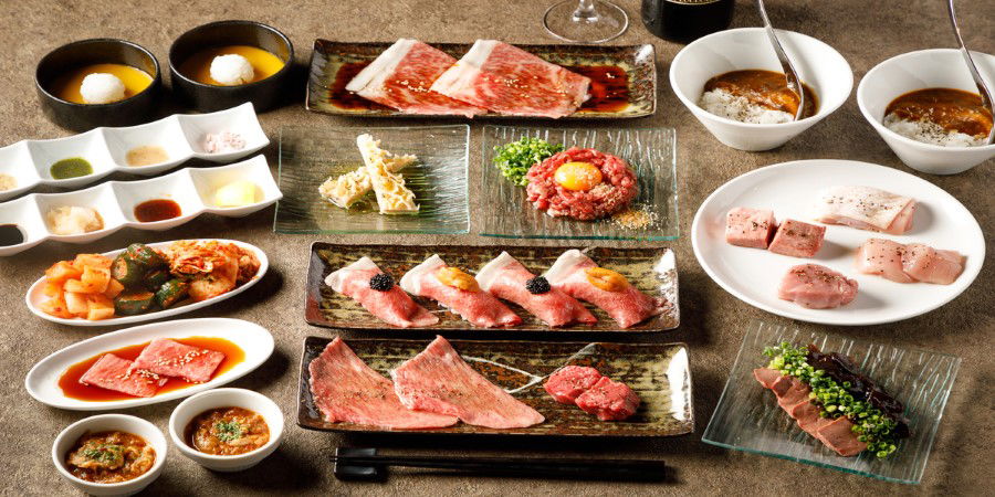 A feast of wagyu beef varieties, served alongside sauces and dips.