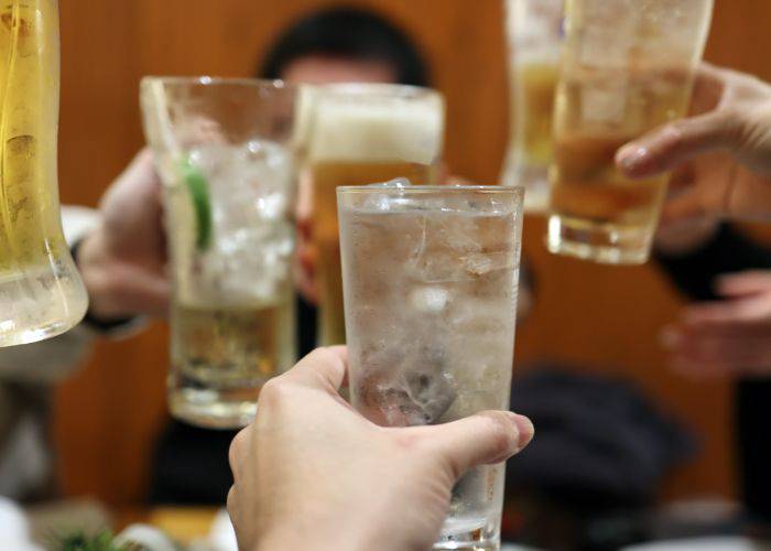 A glass of Okinawan Awamori being raised in cheers.