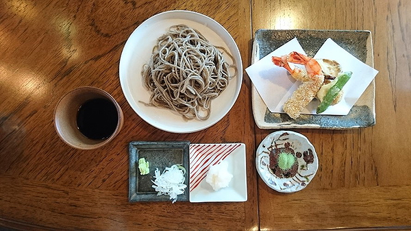 Authentic Japanese soba noodles with tempura on a wooden table