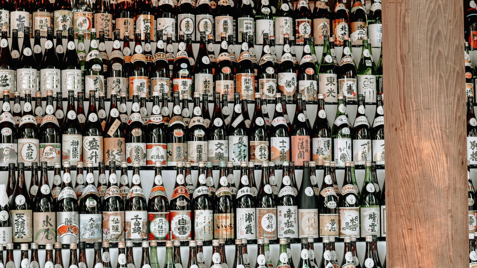 Wall of diverse traditional sake bottles for a cultural ambiance