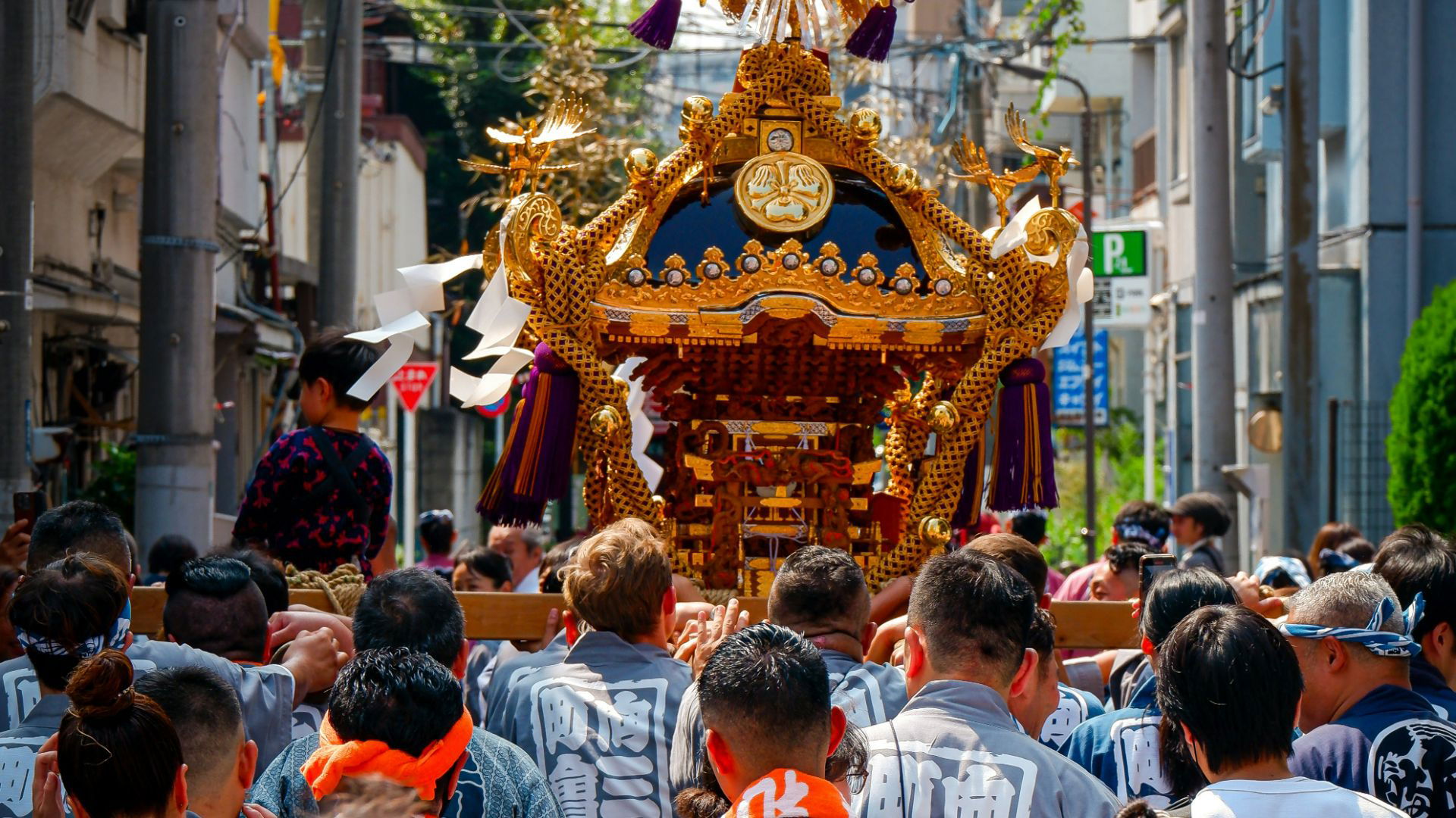 Traditional Japanese festival with ornate portable shrine and participants