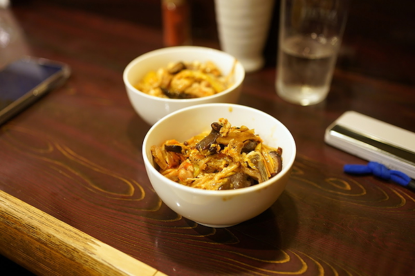 Delicious pasta bowls on wooden restaurant table