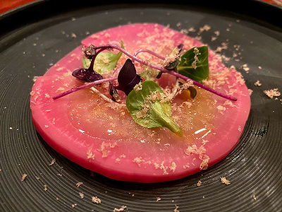 Gourmet pink onion dish with microgreens at fine dining restaurant