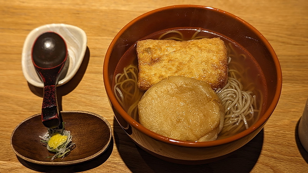 Traditional soba noodle bowl with fried tofu and radish