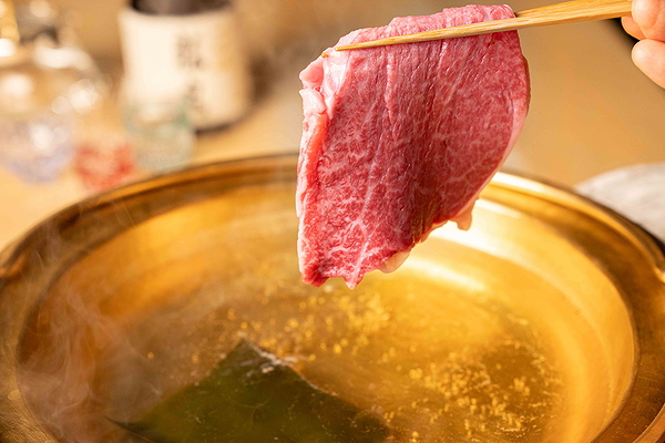 Tender beef slice prepared for shabu-shabu in a hot pot
