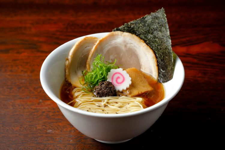 A picturesque bowl of ramen at Chinese Noodles Roku, showing off the noodles, chashu pork and more in style.