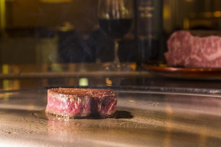 Gourmet steak sizzling on a hot grill in a fine dining restaurant