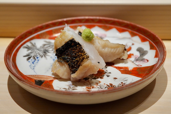 Exquisite nigiri sushi served on ornate Japanese plate