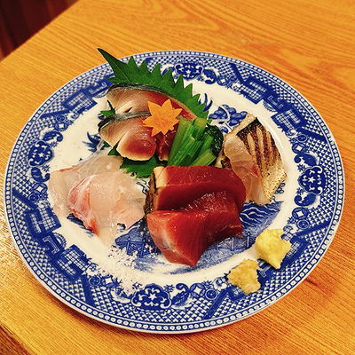 Exquisite sashimi platter on elegant blue and white dish