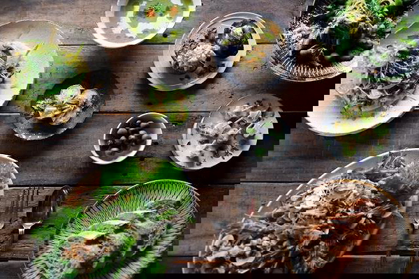 Gourmet vegetarian dishes on rustic wooden table at a restaurant