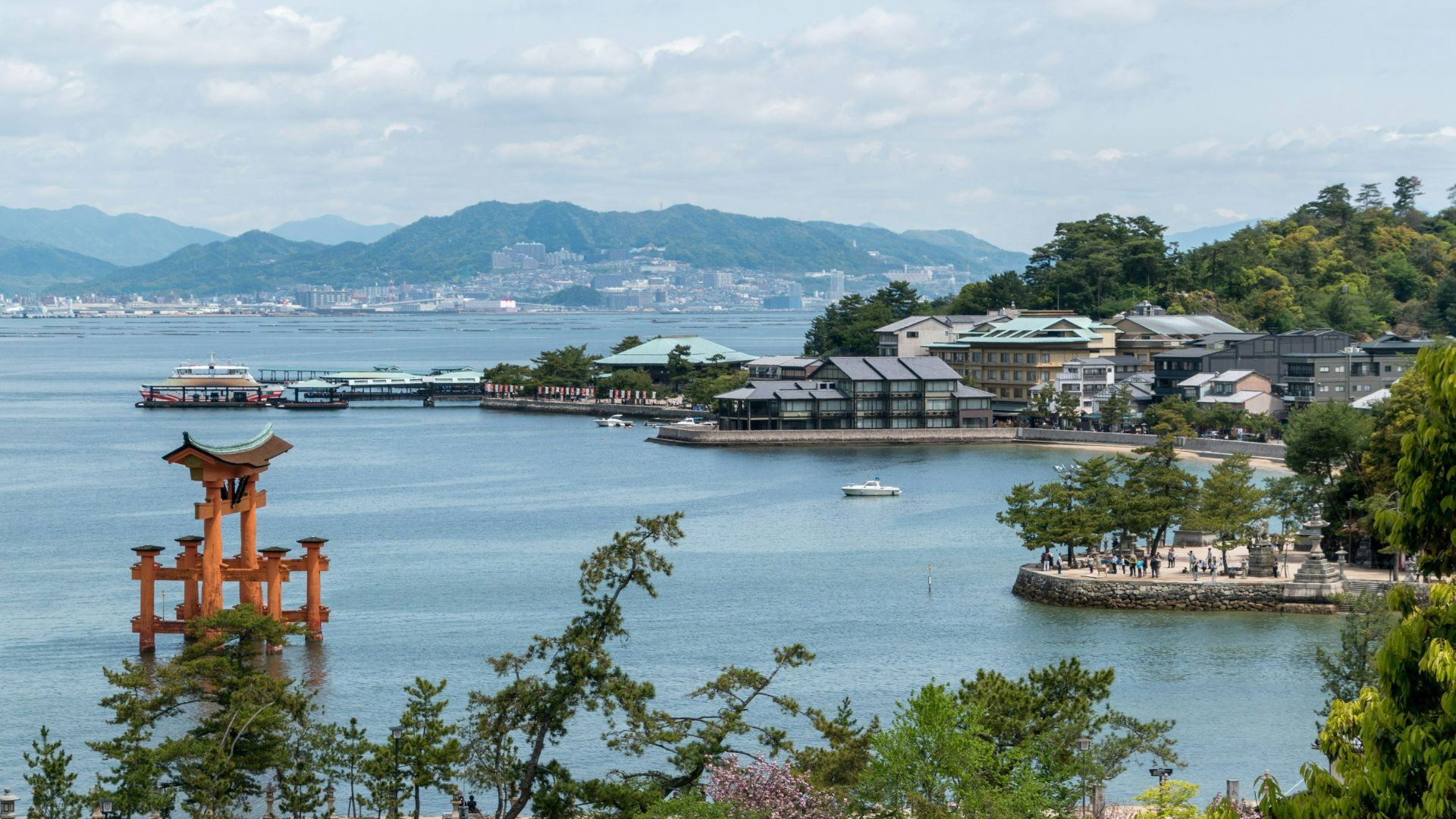 Scenic view of Miyajima Island with floating torii gate and lush landscape