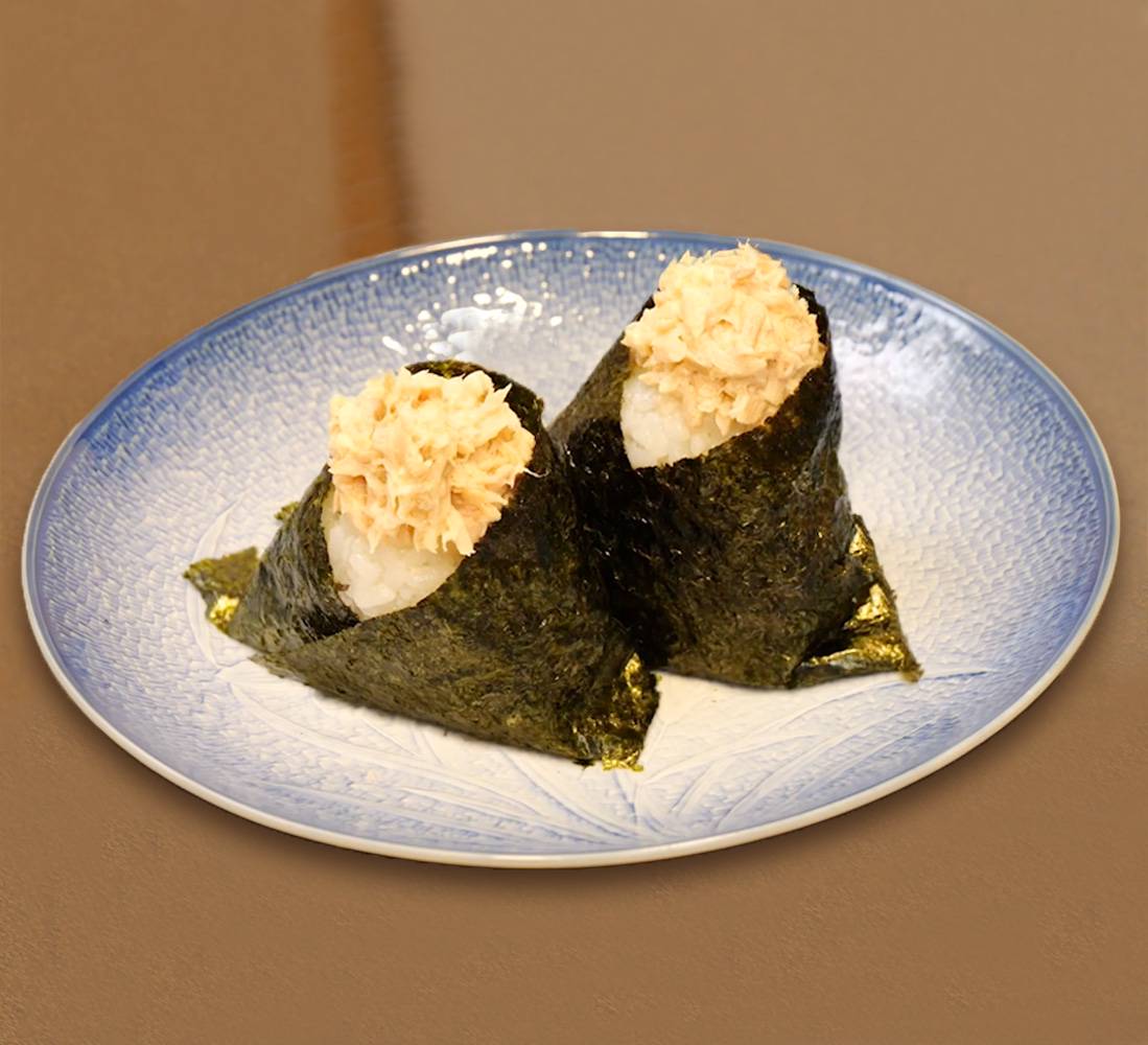 Tuna mayo onigiri rice balls, presented on a blue plate.