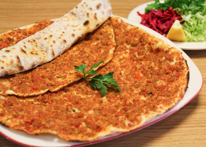 Lahmacun, an oven-baked naan filled with cheese and vegetables.