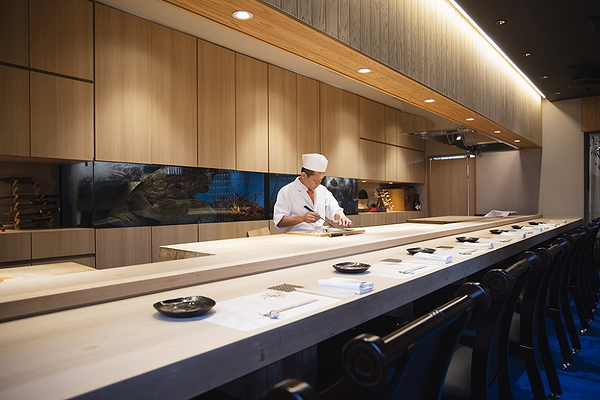 Chef prepares food in an elegant, modern restaurant setting