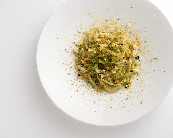 Gourmet pasta dish elegantly presented with herbs and spices