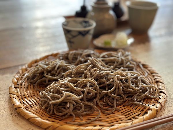 Traditional Japanese soba noodles on a bamboo tray