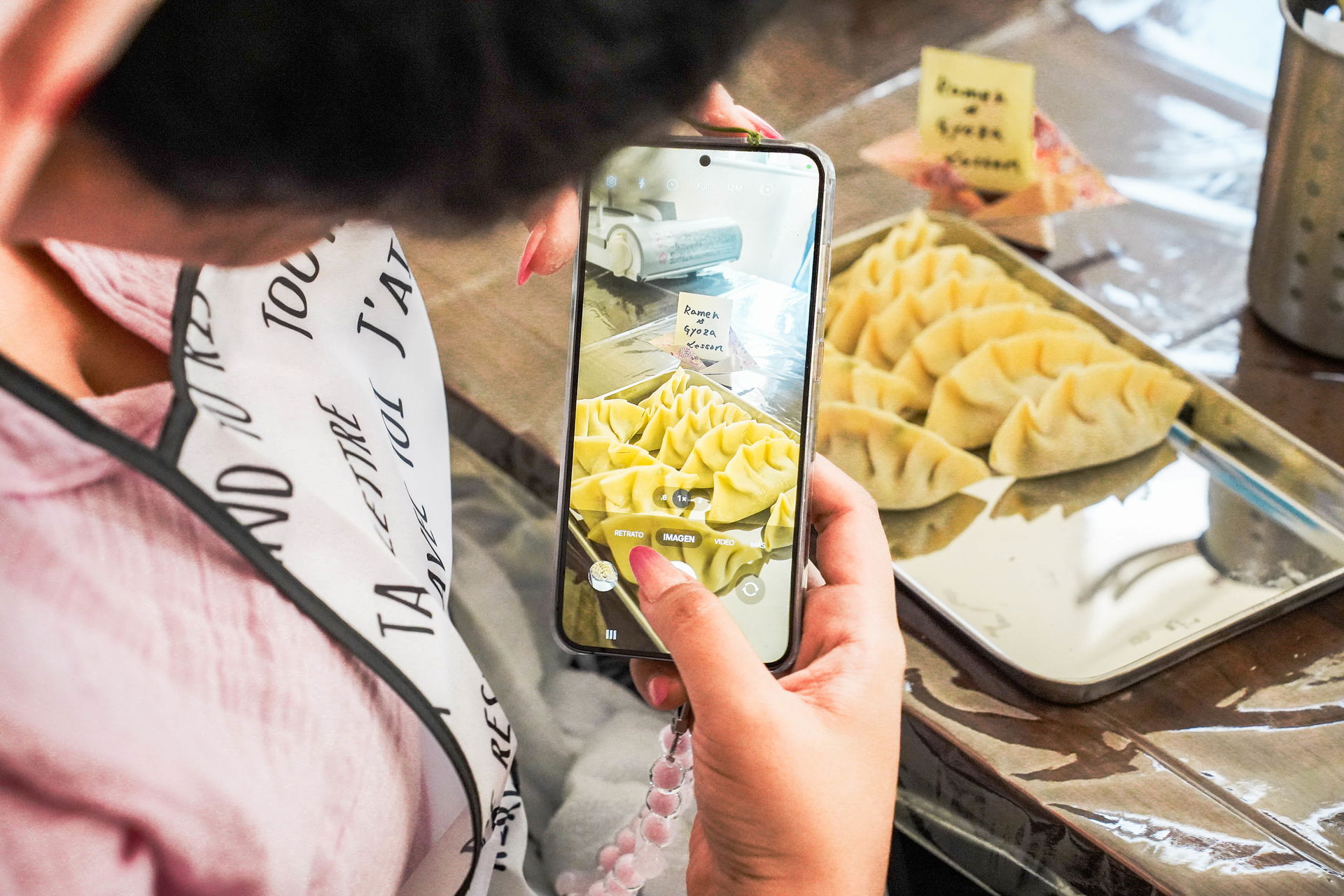 A guest taking a picture of gyoza on their phone in this ramen and gyoza cooking class in Ikebukuro.