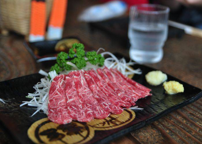 Thin slices of wagyu beef on a serving platter, as might be served at Oaso.