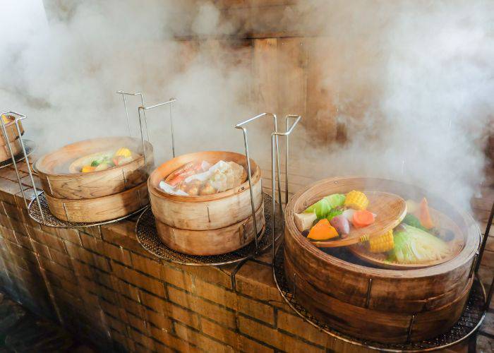 Dishes steaming in Beppu, cooking in the jigoku-mushi style on the steam of the local hot springs.