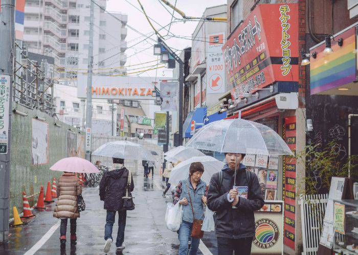 Shimokitazawa on a rainy day. People with umbrellas walk through this district's culture-packed streets.