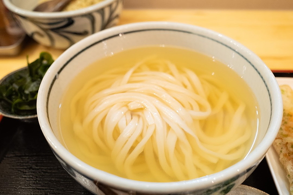 Traditional udon noodles in a savory broth at a Japanese restaurant