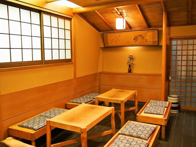 The warm woods and bench seating areas of Izuu.