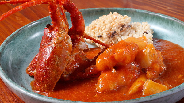 Lobster curry with rice on a blue ceramic plate