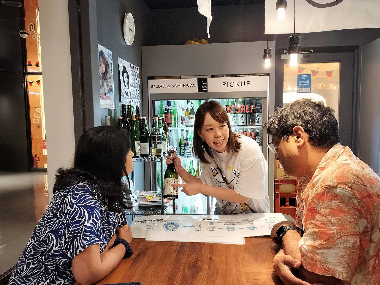 The sake expert explaining a bottle of sake to guests.
