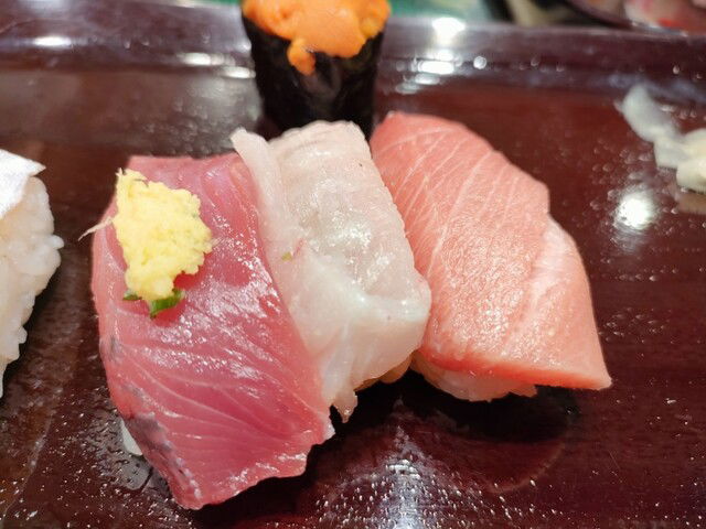 Fresh nigiri sushi at Iwasa Sushi, placing raw fish on top of rice.