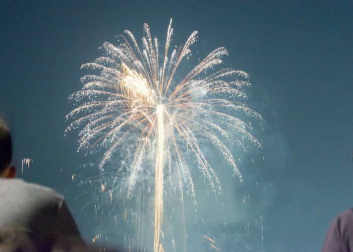 Looking at fireworks over the shoulders of two people in the crowd.