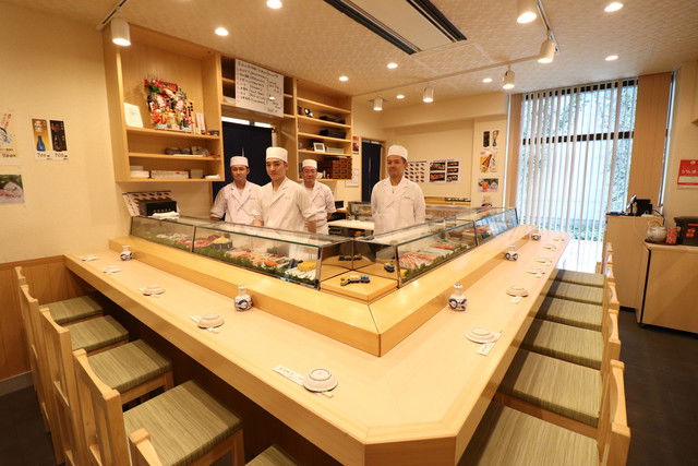 The expert chefs of Sushidokoro Yamazaki, waiting behind the counter for hungry guests.