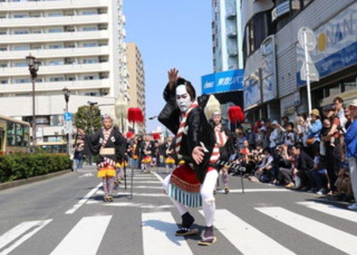 Man with a painted white face dancing during the Ooka-Echizen Festival