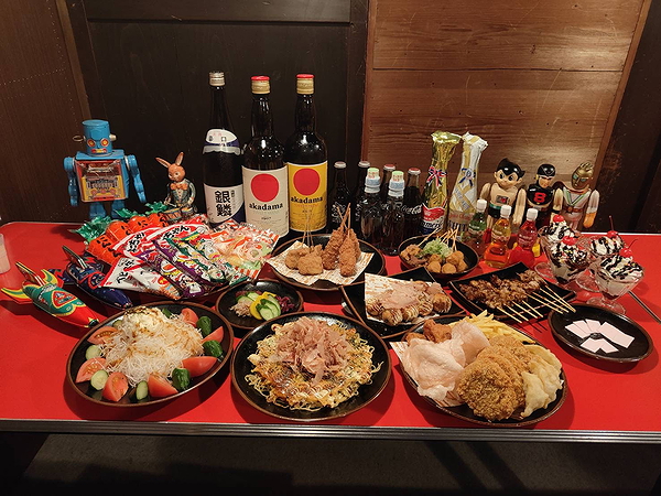 A Japanese feast with drinks, snacks, and action figures on display