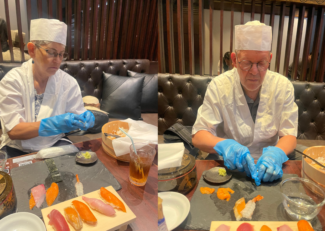 Two guests working hard to make sushi in this Akihabara cooking class.